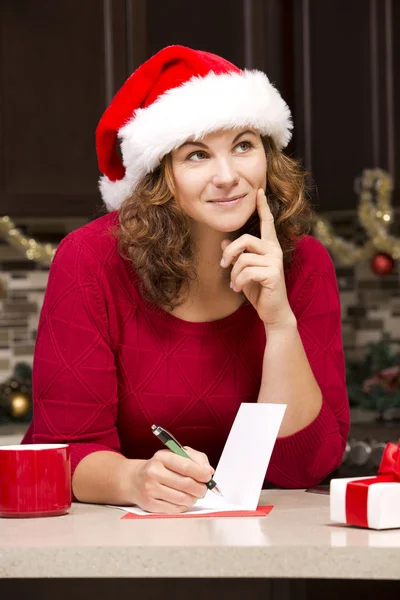 Woman writing Christmas card — Stock Photo, Image