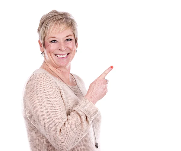 Casual mature woman pointing — Stock Photo, Image