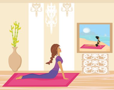 Evde yoga yapan genç bir kadın.