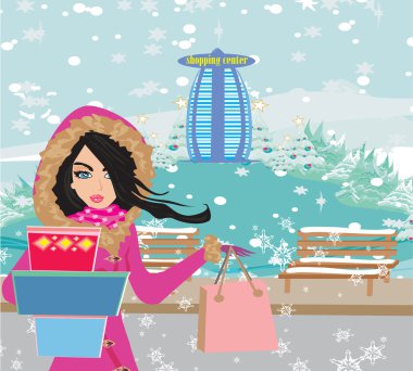 Güzel bir kadın kışın alışverişe çıkıyor. 