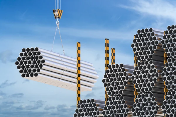 Crane hook with steel pipes on the blue sky — Stock Photo, Image