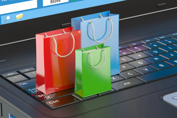 Σε απευθείας σύνδεση internet ψώνια έννοια, φορητού υπολογιστή και τσάντες αγορών — Φωτογραφία Αρχείου