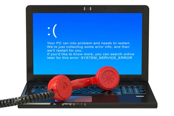 Laptop with blue error screen and handset — Zdjęcie stockowe