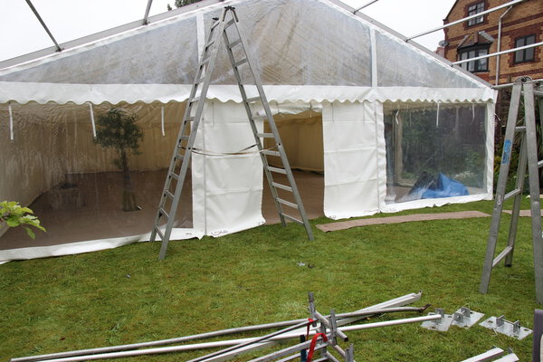 Erecting a marquee in a garden for a wedding