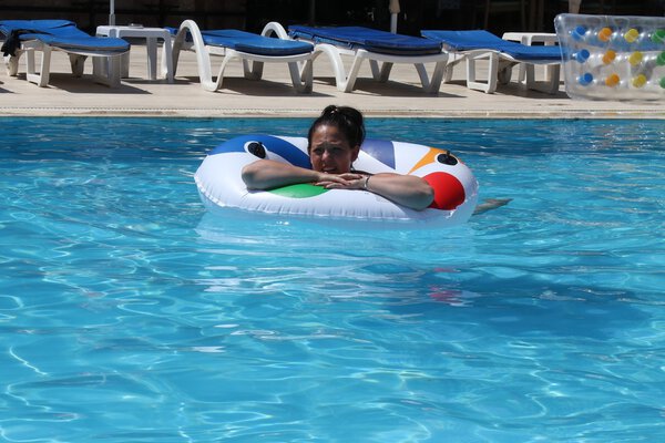 A young lady cooling off in a swimming pool 