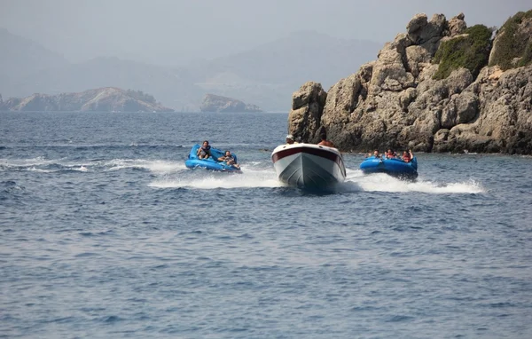 Tourists having fun riding in inflatables — Stock Photo, Image