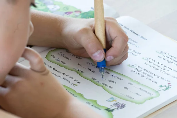 German boy learns at home with his mother - booklet with german words