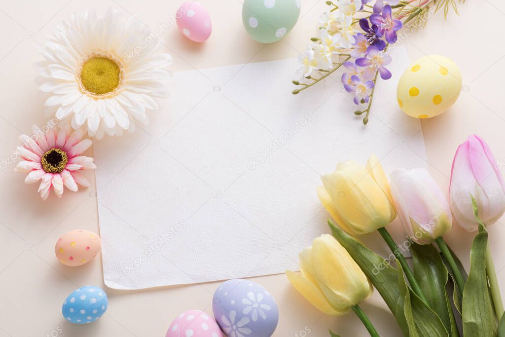 Happy Easter day colorful eggs and flower decoration on paper background with copy space.