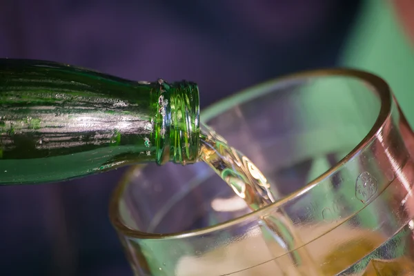 Beer is poured into a glass in studio — Stock Photo, Image