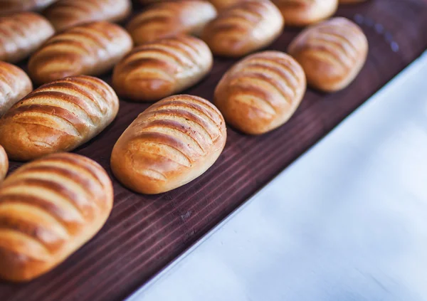 Выпечка хлеба на производственной линии в пекарне — стоковое фото
