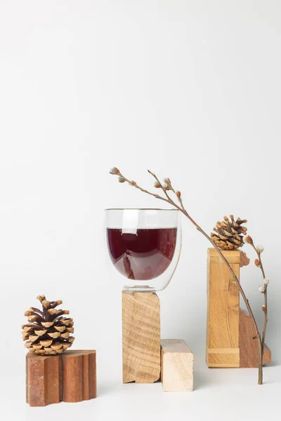 Russian carbonated drink Baikal, with a tonic effect. It is based on natural herbs, eleutherococcus, licorice, eucalyptus and essential oils of coniferous plants. Still life with wooden stands, cones.On a white background, vertical