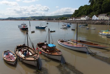 Boast in Minehead harbour Somerset England in summer with blue sky on a beautiful day clipart