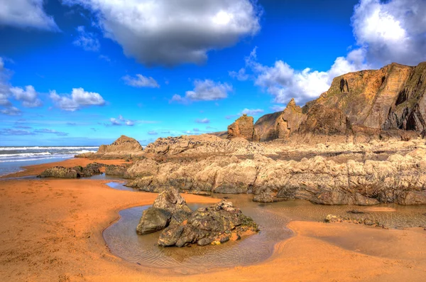 Sandymouth beach North Cornwall England UK beautiful rocks with unusual patterns in colourful HDR — Stock Photo, Image