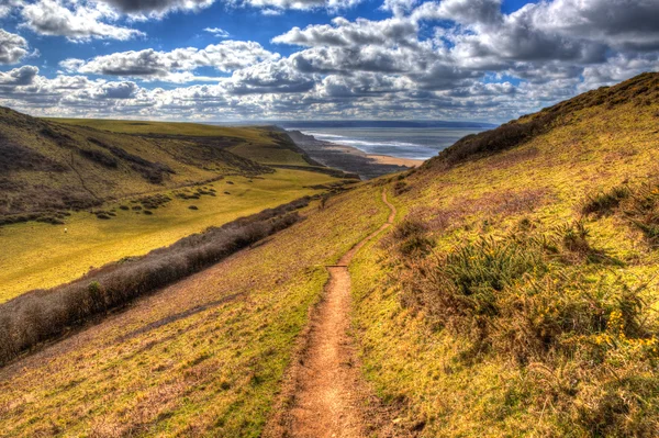 Path to UK atlantic coast Sandymouth North Cornwall England UK on the south west coast path towards Bude in colourful HDR