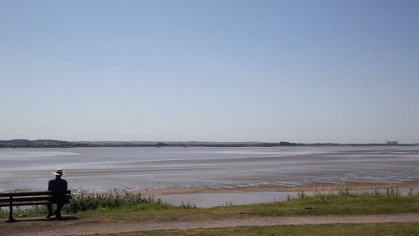 Lydney harbour view across the River Severn estuary towards the Severn bridge England uk with pan to picnic area and stones — Stock Video