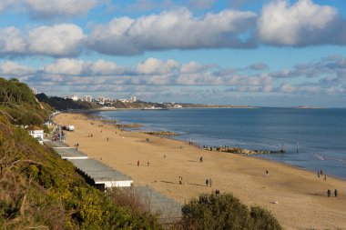 Sunny weather brought visitors to Branksome beach Poole on the Dorset coast to enjoy the winter sunshine