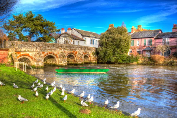 River Avon Christchurch Dorset England UK with bridge and green boat like a painting in vivid bright colourful HDR — Stock Photo, Image