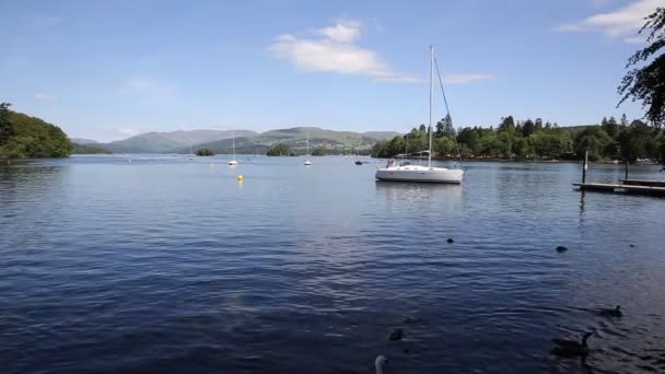 Bowness Windermere Lake District England uk with a sailing boat at this popular tourist location — Stock Video