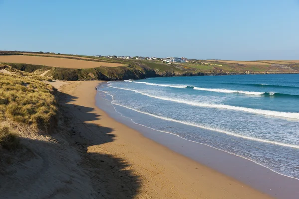 Crantock beach view to West Pentire and Bowgie Inn North Cornwall England UK near Newquay in spring with blue sky and sea