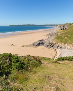 Pobbles beach The Gower Peninsula Wales uk popular tourist destination and next to Three Cliffs Bay in summer with blue sky and sea