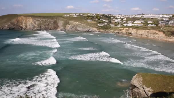 Пляж для серфинга недалеко от Ньюкай города Мауган Порт к северу от Корнуолла в Англии в летний день с голубым небом на атлантическом побережье Корниша — стоковое видео