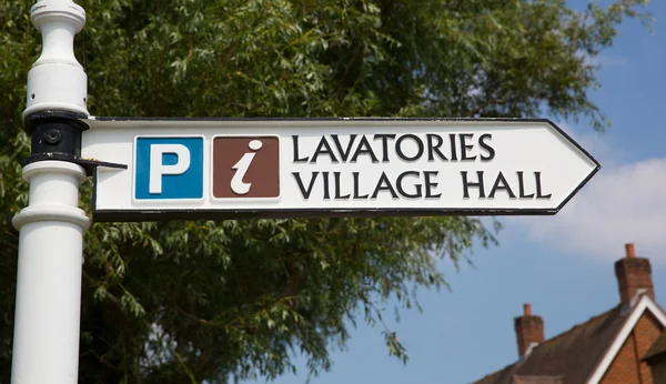 Sign to lavatories and village hall — Stock Photo, Image