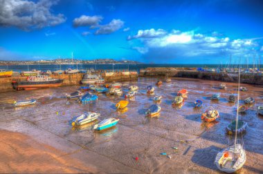 Paignton Devon England uk harbour in colourful HDR with boats at low tide and view to Torquay clipart