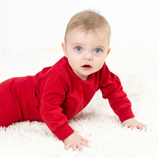 Small Child Lies His Stomach White Carpet — Stock Photo, Image