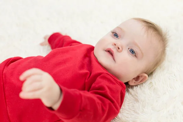 Caucasian Baby Red Clothes Lies His Back — Stock Photo, Image