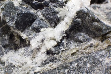 White fibers of asbestos mineral in stone close-up. clipart