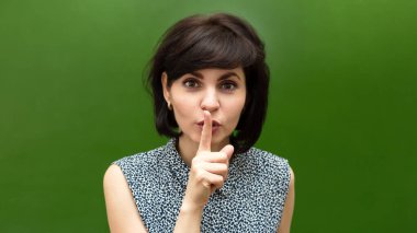 Okuldaki öğretmen el hareketleriyle sessizliğini gösteriyor..