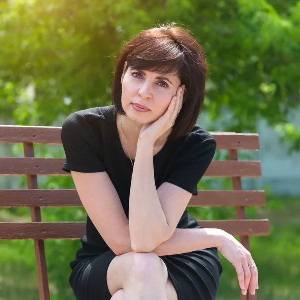 Retrato Una Joven Feliz Con Vestido Negro Banco Parque —  Fotos de Stock