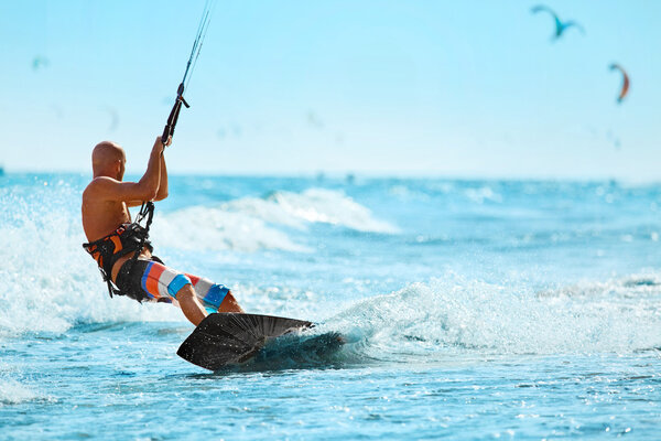 Recreational Sports. Man Kiteboarding In Sea Water. Extreme Sport