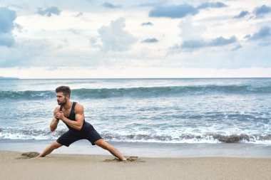 Man Doing Stretching Workout Exercises, Exercising At Beach. Fitness