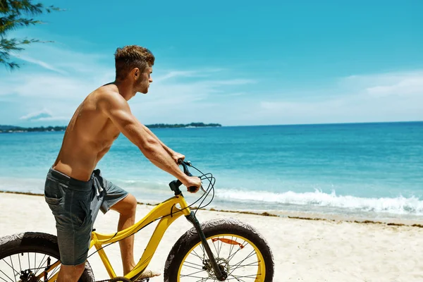 Hombre montando en bicicleta de arena en la playa. Actividad deportiva de verano —  Fotos de Stock