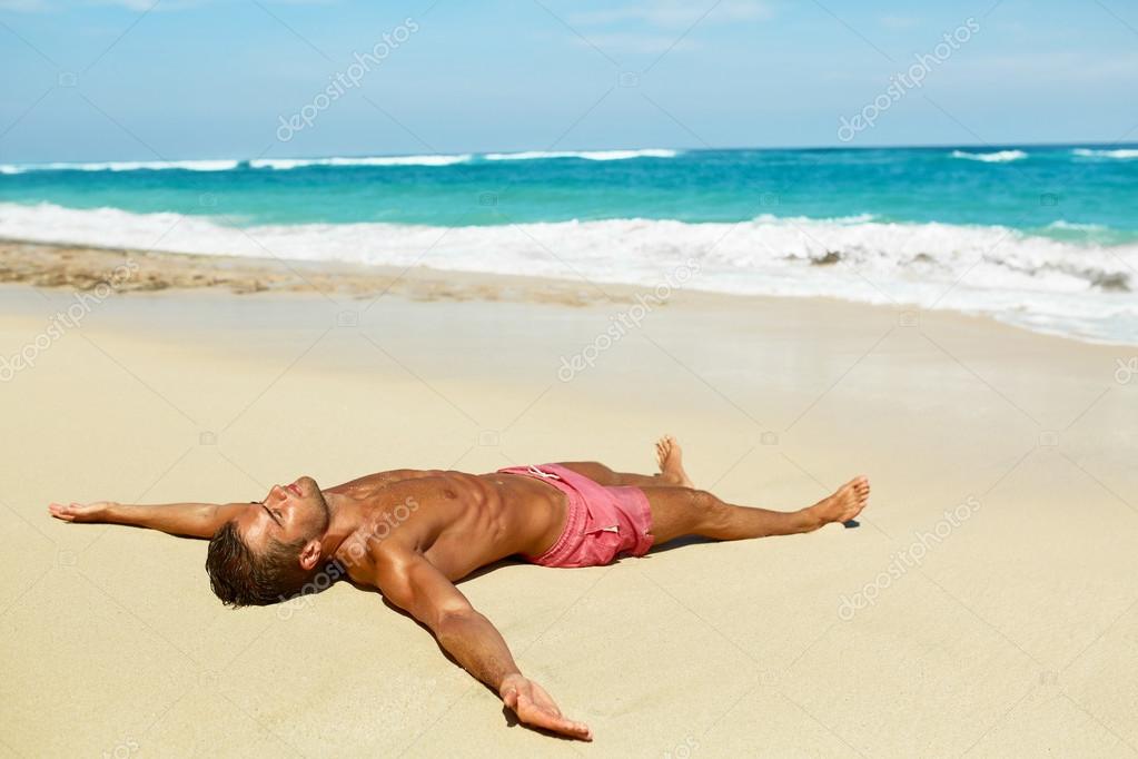 Man Body On Beach. Summer Male Lying On Sand At Resort Stock Photo by  ©puhhha 113140738