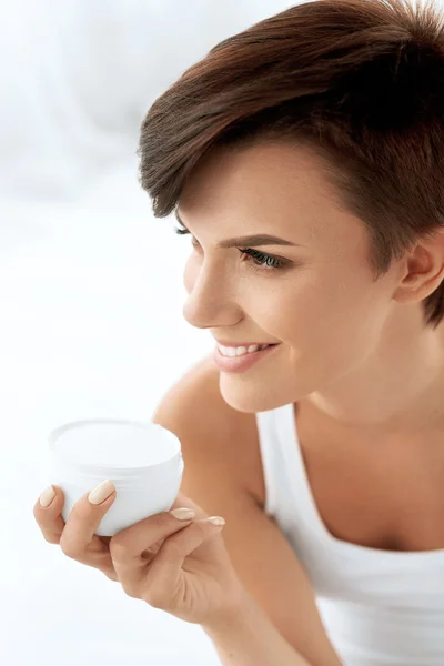 Skin Care. Beautiful Happy Woman Holding Face Cream, Lotion