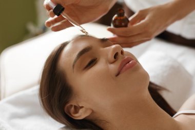 Face Skin Care. Woman Receiving Serum Treatment In Beauty Salon clipart
