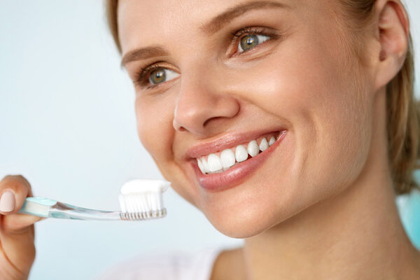 Beautiful Smiling Woman Brushing Healthy White Teeth With Brush