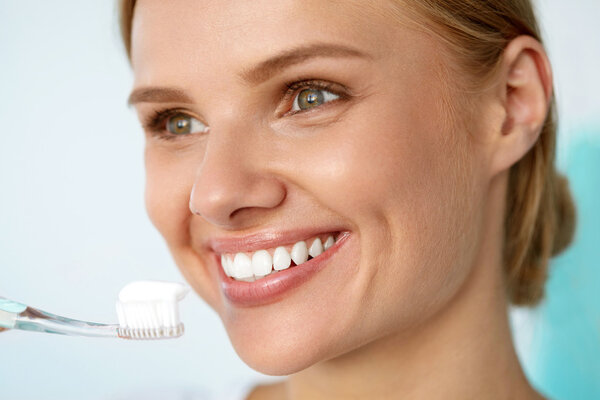 Beautiful Smiling Woman Brushing Healthy White Teeth With Brush