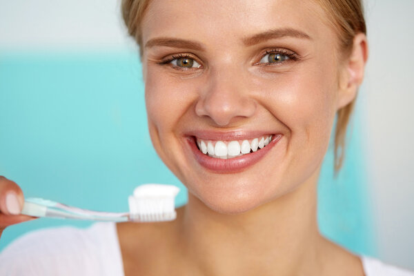 Beautiful Smiling Woman Brushing Healthy White Teeth With Brush