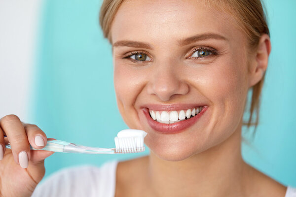 Woman With Beautiful Smile Brushing Healthy White Teeth