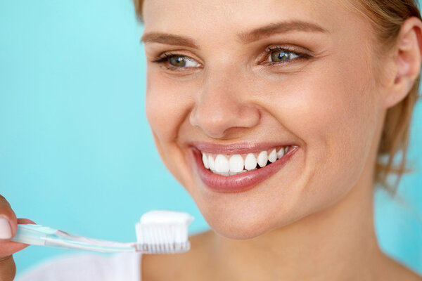 Woman With Beautiful Smile Brushing Healthy White Teeth