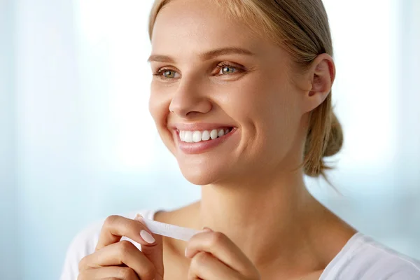 Woman Using Teeth Whitening Strip For Beautiful White Smile — Stock fotografie