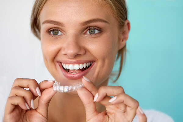 Smiling Woman With Beautiful Smile Using Teeth Whitening Tray