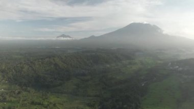 Endonezya, Bali 'deki Agung Dağı' nın havadan görünüşü. Tropikal Orman ve Vadi 'de palmiye ağaçları ve volkan yakınlarında evleri var..