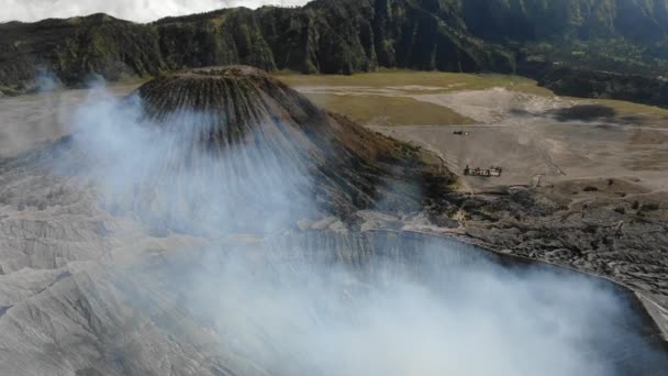 Mount Bromo is smoky active volcano with crater — Stock Video