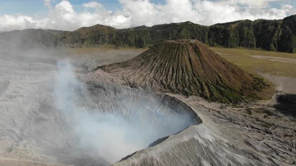 Mount Bromo is smoky active volcano with crater — Stock Video
