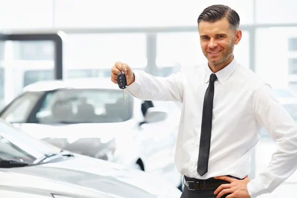 Salesman in Car Showroom. — Stock Photo, Image