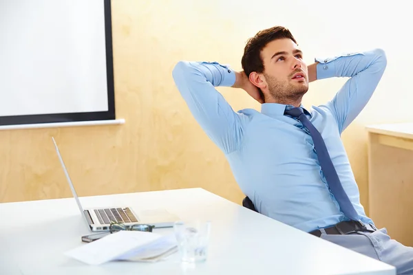 Geschäftsmann sitzt in einem hellen Büro — Stockfoto